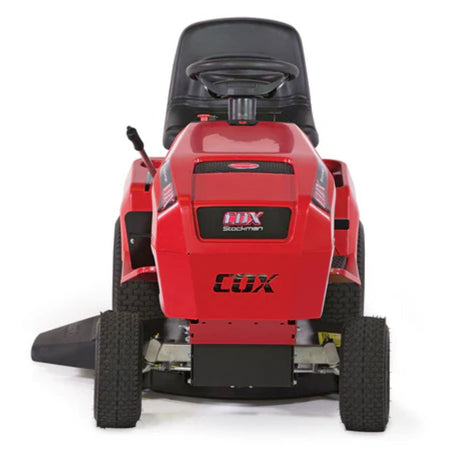 Red Cox Stockman ride on mower seen from the from angle on white background.